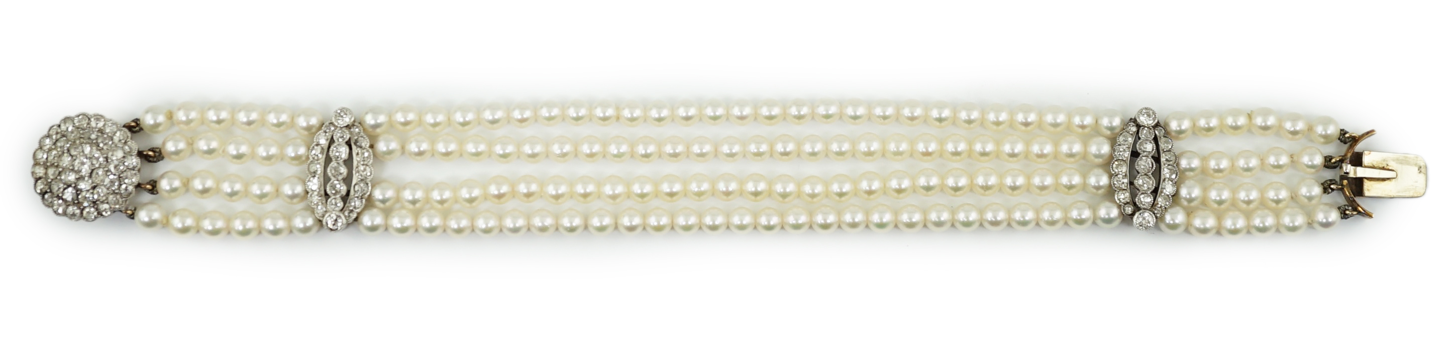 A multi-strand cultured pearl bracelet, with circular diamond cluster set gold clasp